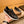 PRA SNEAKER IN BLACK CALFSKIN WITH GLOSSY GOLDEN
