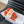 WOVEN SLIDE IN RAFFIA AND VIVID ORANGE LAMBSKIN