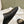 FLAT MULES IN BLACK SMOOTH CALFSKIN GOLD BUCKLE