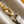 CAPUCINES BB 27 DARK BEIGE TAURILLON GOLD HARDWARE