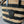 STRIPED COUFFIN CLASSIC PANIER 22 IN BEIGE AND BLACK RAFFIA AND CALFSKIN TRIM