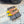 ALAIA FLAT SLINGBACK IN YELLOW PATENT CALFSKIN AND FILM