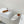 ALAIA VIENNE FLAT MULES IN WHITE LAMBSKIN